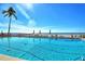 Beautiful community pool with ocean views, palm trees, lounge chairs and beach access at 2301 Gulf Of Mexico Dr # 26N, Longboat Key, FL 34228