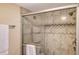 Updated walk-in shower with decorative tile and glass door at 2301 Gulf Of Mexico Dr # 26N, Longboat Key, FL 34228