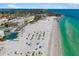 Expansive aerial view of the beach, showcasing the turquoise water, white sand, and nearby residential buildings at 2311 Sunnyside Pl, Sarasota, FL 34239
