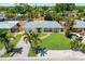 Well-maintained single-story home with a manicured lawn, brick pathway, and a serene neighborhood setting at 2311 Sunnyside Pl, Sarasota, FL 34239