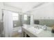 Well-lit bathroom with a shower/tub combo, large mirror, and tile backsplash at 2311 Sunnyside Pl, Sarasota, FL 34239