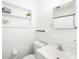 Clean bathroom with white tile, classic fixtures and plenty of shelf space at 2311 Sunnyside Pl, Sarasota, FL 34239