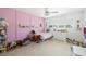 Bright bedroom with pink accent wall and plenty of light from the windows at 2311 Sunnyside Pl, Sarasota, FL 34239