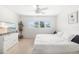 Bright bedroom with white walls, ceiling fan, and natural light from the windows at 2311 Sunnyside Pl, Sarasota, FL 34239