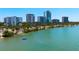 A picturesque scene featuring a blue waterway and a city skyline under a clear sky at 2311 Sunnyside Pl, Sarasota, FL 34239