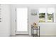 Charming entryway with front door, side window, and a small table with decor at 2311 Sunnyside Pl, Sarasota, FL 34239