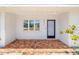 Charming front porch with brick flooring and a freshly painted front door at 2311 Sunnyside Pl, Sarasota, FL 34239