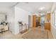 Hallway with hardwood floors, leading to kitchen and living area, with open sightlines at 2311 Sunnyside Pl, Sarasota, FL 34239