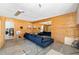 Inviting living room features wood paneling, large mirror, and a comfortable blue sofa at 2311 Sunnyside Pl, Sarasota, FL 34239