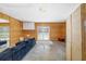 Spacious living room with wood paneling, lots of natural light, and a comfortable blue sofa at 2311 Sunnyside Pl, Sarasota, FL 34239
