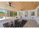Charming enclosed patio with outdoor seating and view of the pool and well-maintained yard at 2311 Sunnyside Pl, Sarasota, FL 34239