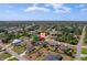 Expansive aerial view of a neighborhood showcasing homes with well-manicured lawns and mature trees at 2366 Ann Arbor Rd, North Port, FL 34286