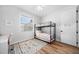 Light bedroom with bunk beds, white walls, wood floor, and light from a sunny window at 2366 Ann Arbor Rd, North Port, FL 34286
