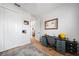 Bedroom features wood floors, grey rug, desk, and closet with white bi-fold doors at 2366 Ann Arbor Rd, North Port, FL 34286