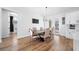 Open dining area with chandelier, hardwood floors, and sliding glass doors to backyard at 2366 Ann Arbor Rd, North Port, FL 34286