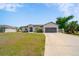 Charming single-story home features a two-car garage, well-manicured lawn, and a classic design at 2366 Ann Arbor Rd, North Port, FL 34286