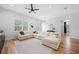 Cozy living room features a large sectional sofa, neutral decor, and seamless flow to outdoor spaces at 2366 Ann Arbor Rd, North Port, FL 34286