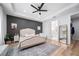 Bedroom with accent wall, hardwood floors, neutral tones, and a seating area at 2366 Ann Arbor Rd, North Port, FL 34286