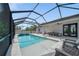 Beautiful screened-in pool and hot tub, with tile decking and outdoor living area at 2366 Ann Arbor Rd, North Port, FL 34286