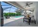 The outdoor screened-in pool area features a table and chairs and a built-in spa at 2366 Ann Arbor Rd, North Port, FL 34286