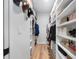 Spacious walk-in closet with custom shelves for clothing and accessories at 2366 Ann Arbor Rd, North Port, FL 34286