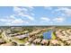 Wide aerial shot showcasing houses, manicured lawns, and scenic lake views in a quiet residential neighborhood at 2705 Taheebo Way, North Port, FL 34289