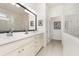 Bathroom features a double sink vanity and a large mirror at 2705 Taheebo Way, North Port, FL 34289