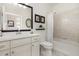 Bright bathroom featuring a modern vanity with white cabinets, a shower-tub combination and neutral wall and floor tiles at 2705 Taheebo Way, North Port, FL 34289