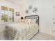 Cozy bedroom with a comfortable bed, shutters, and stylish decor at 2705 Taheebo Way, North Port, FL 34289