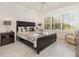 Bedroom featuring a decorative ceiling fan and large window for ample natural light at 2705 Taheebo Way, North Port, FL 34289