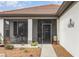 Inviting screened front porch with a welcoming entrance, surrounded by lovely plants and decor at 2705 Taheebo Way, North Port, FL 34289