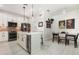 Elegant kitchen featuring an island with seating and stainless steel appliances at 2705 Taheebo Way, North Port, FL 34289