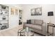 Cozy sitting area with built-in bookshelves, a comfortable couch, and glass table at 2705 Taheebo Way, North Port, FL 34289