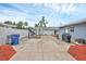 Open backyard featuring a concrete patio, car lift, and a partial view of the home's exterior at 2715 52Nd Avenue W Ter, Bradenton, FL 34207