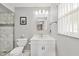 Bright bathroom with a modern vanity, toilet, and a tiled shower at 2715 52Nd Avenue W Ter, Bradenton, FL 34207