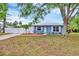 Charming single-story home with a blue exterior, metal roof, and well-manicured landscaping at 2715 52Nd Avenue W Ter, Bradenton, FL 34207