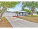Charming single-story home with a long driveway and white fence providing curb appeal at 2715 52Nd Avenue W Ter, Bradenton, FL 34207