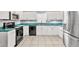 Bright kitchen featuring stainless steel appliances, white cabinets, and dark countertops at 2715 52Nd Avenue W Ter, Bradenton, FL 34207