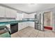 Updated kitchen featuring stainless steel appliances, white cabinets, and tiled flooring at 2715 52Nd Avenue W Ter, Bradenton, FL 34207