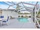 Backyard pool area enclosed with a screened-in patio, featuring a uniquely shaped pool at 2715 52Nd Avenue W Ter, Bradenton, FL 34207