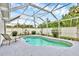 Backyard pool area enclosed with a screened-in patio and a white privacy fence at 2715 52Nd Avenue W Ter, Bradenton, FL 34207