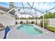 Backyard pool area enclosed with a screened-in patio, with lots of foliage and a pool float at 2715 52Nd Avenue W Ter, Bradenton, FL 34207