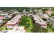 Aerial view of the condo complex with mature trees and lush lawns at 3500 Beneva Rd # 306, Sarasota, FL 34232