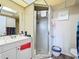 This bathroom is well-lit and features a shower with glass doors at 3500 Beneva Rd # 306, Sarasota, FL 34232