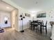 Open-concept dining area featuring hardwood floors, modern lighting fixture, and decorative wall art at 3500 Beneva Rd # 306, Sarasota, FL 34232