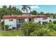 Building exterior with balconies and tropical landscaping at 3500 Beneva Rd # 306, Sarasota, FL 34232