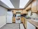 Kitchen features wooden cabinets, a white refrigerator and oven, and plenty of counter space at 3500 Beneva Rd # 306, Sarasota, FL 34232