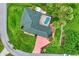 Overhead aerial view of a well-maintained home with a screened-in pool and meticulously landscaped surroundings at 3530 Adelaide Ave, North Port, FL 34288