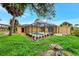 Landscaped backyard with a pool, screened lanai, and storage shed at 3530 Adelaide Ave, North Port, FL 34288
