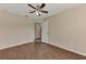 Bedroom with ceiling fan, wood floors, and closet at 3530 Adelaide Ave, North Port, FL 34288